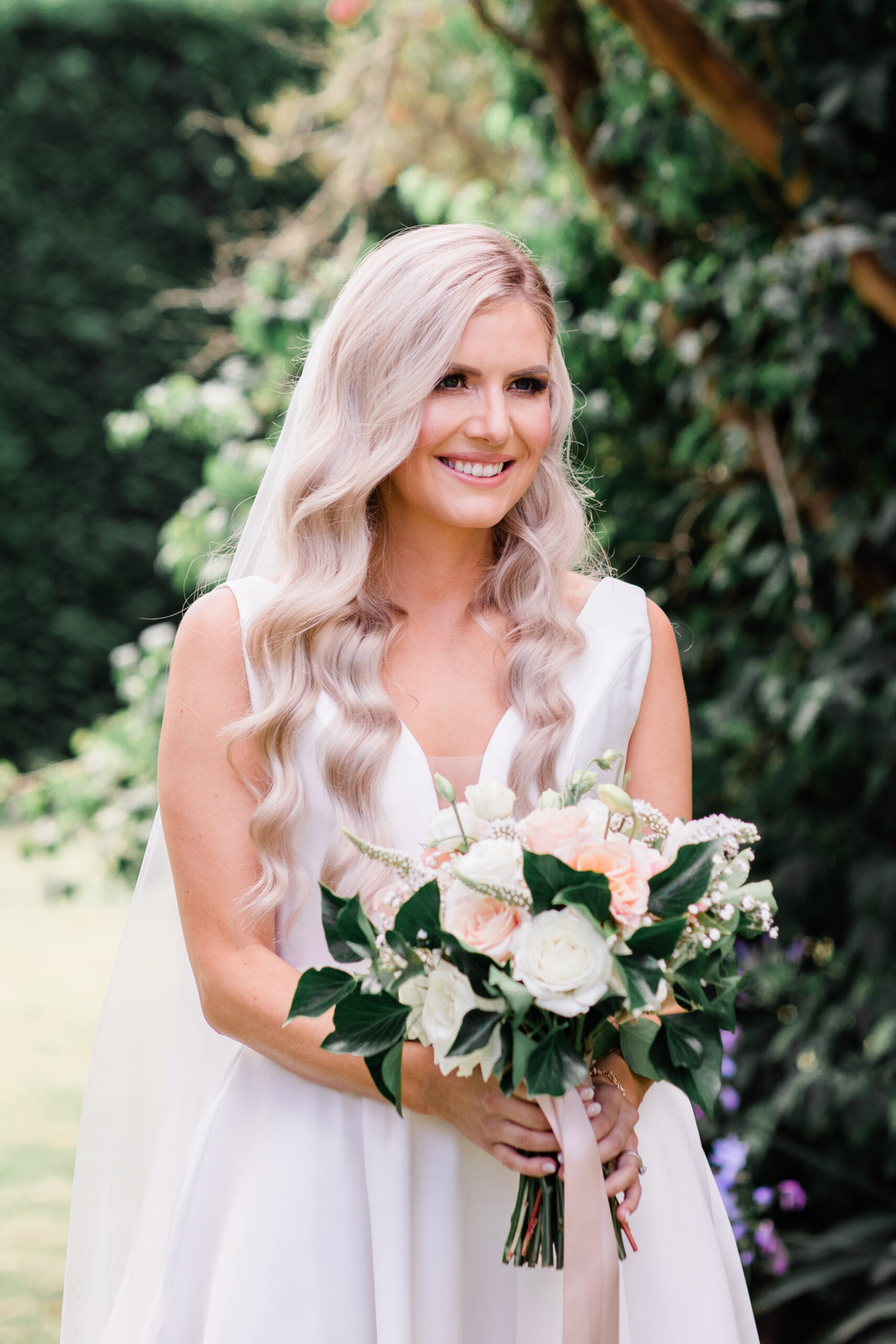 a bride holding flowers is captured by her wellington wedding photographer